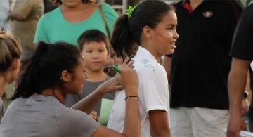 Image of a wahine athlete signing a your girls shirt