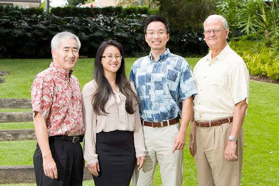 From left to right: Allen Uyeda, president and CEO, FICOH; Shylyn Duarte and Kenneth Lee, FICOH’s first scholarship recipients; and V. Vance Roley, dean, Shidler College of Business